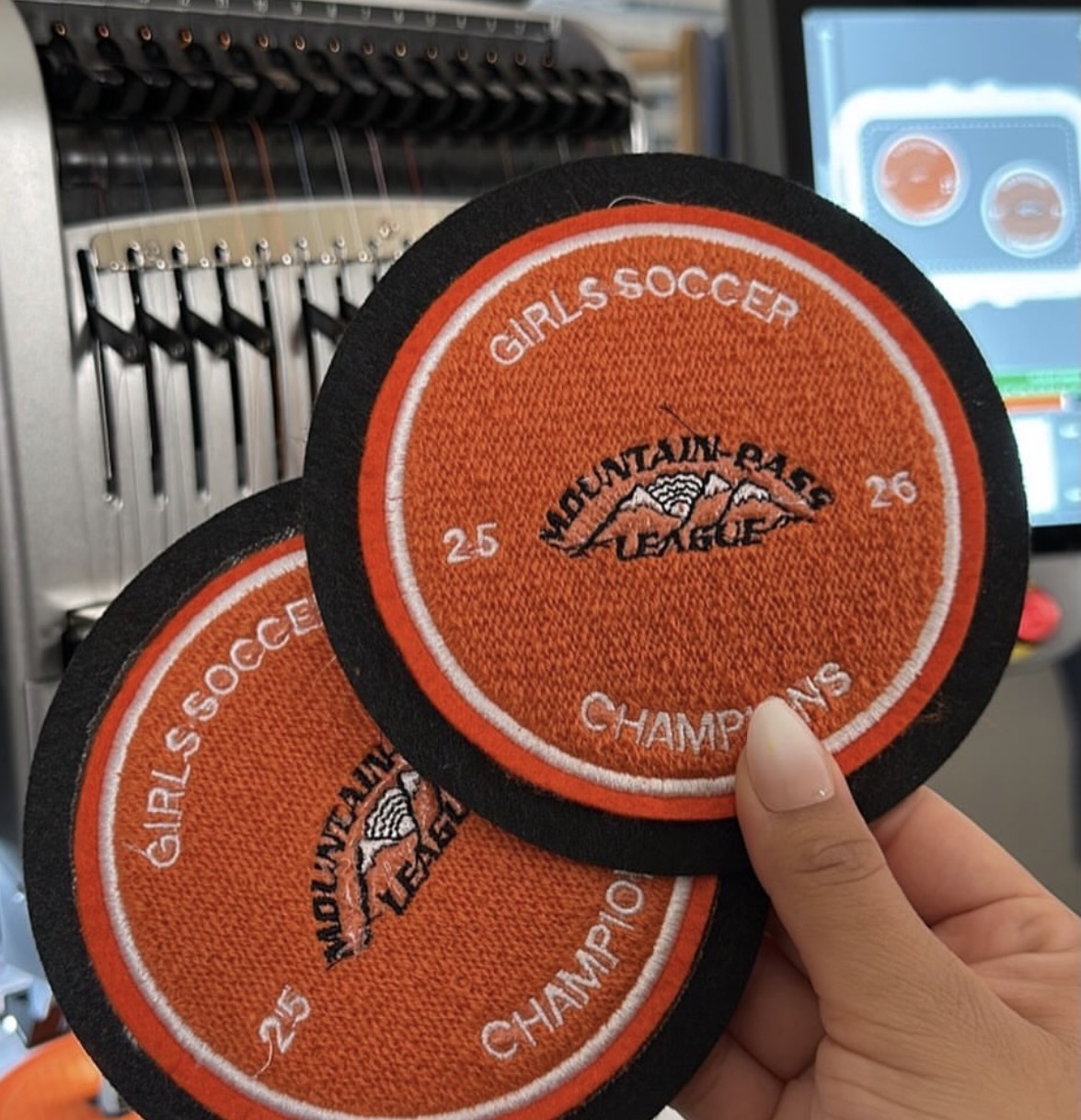 Mountain Pass League girls soccer championship patches on embroidery machine